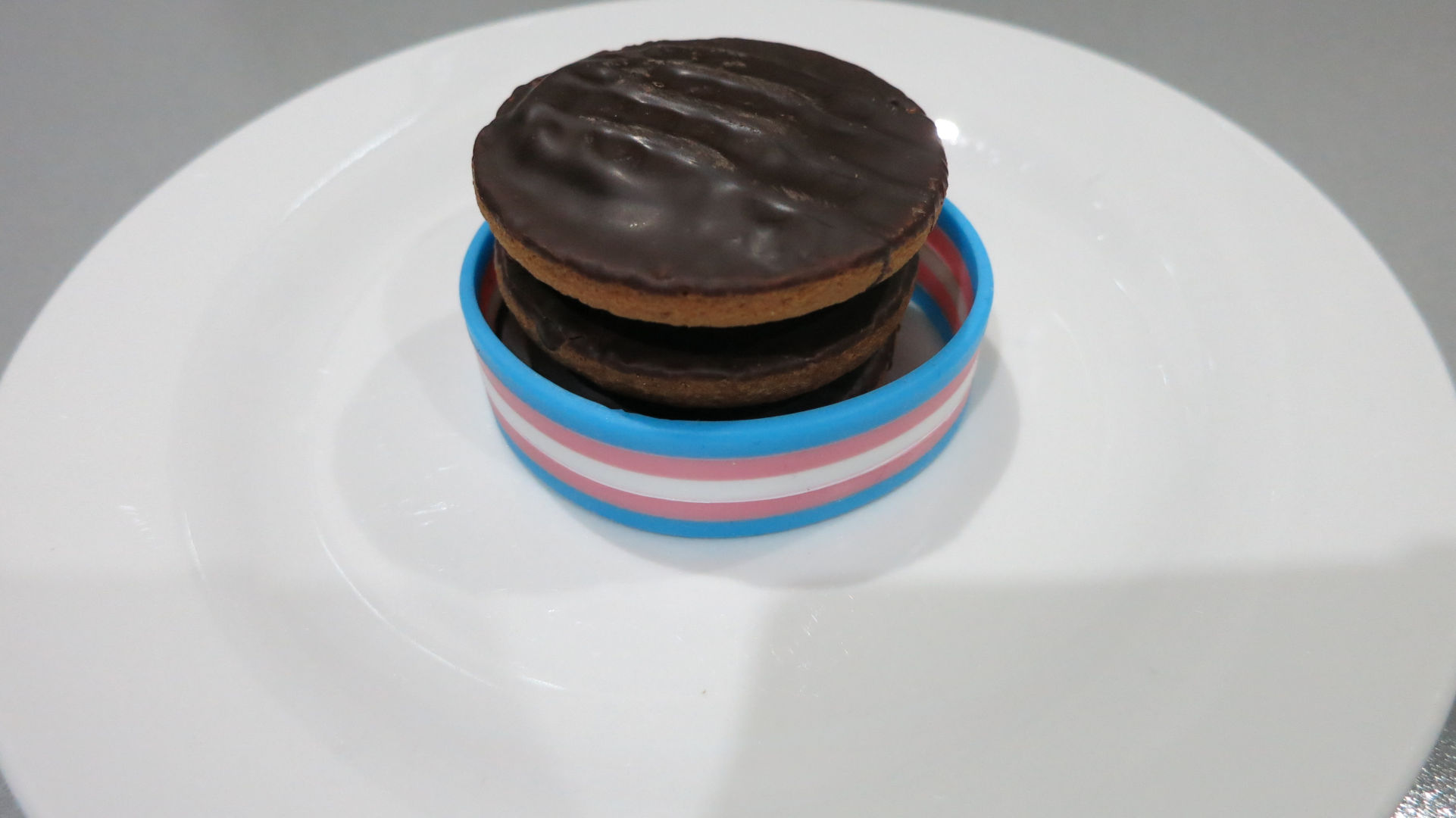 A stack of JaffaCakes, wrapped in the transgender pride flag.
